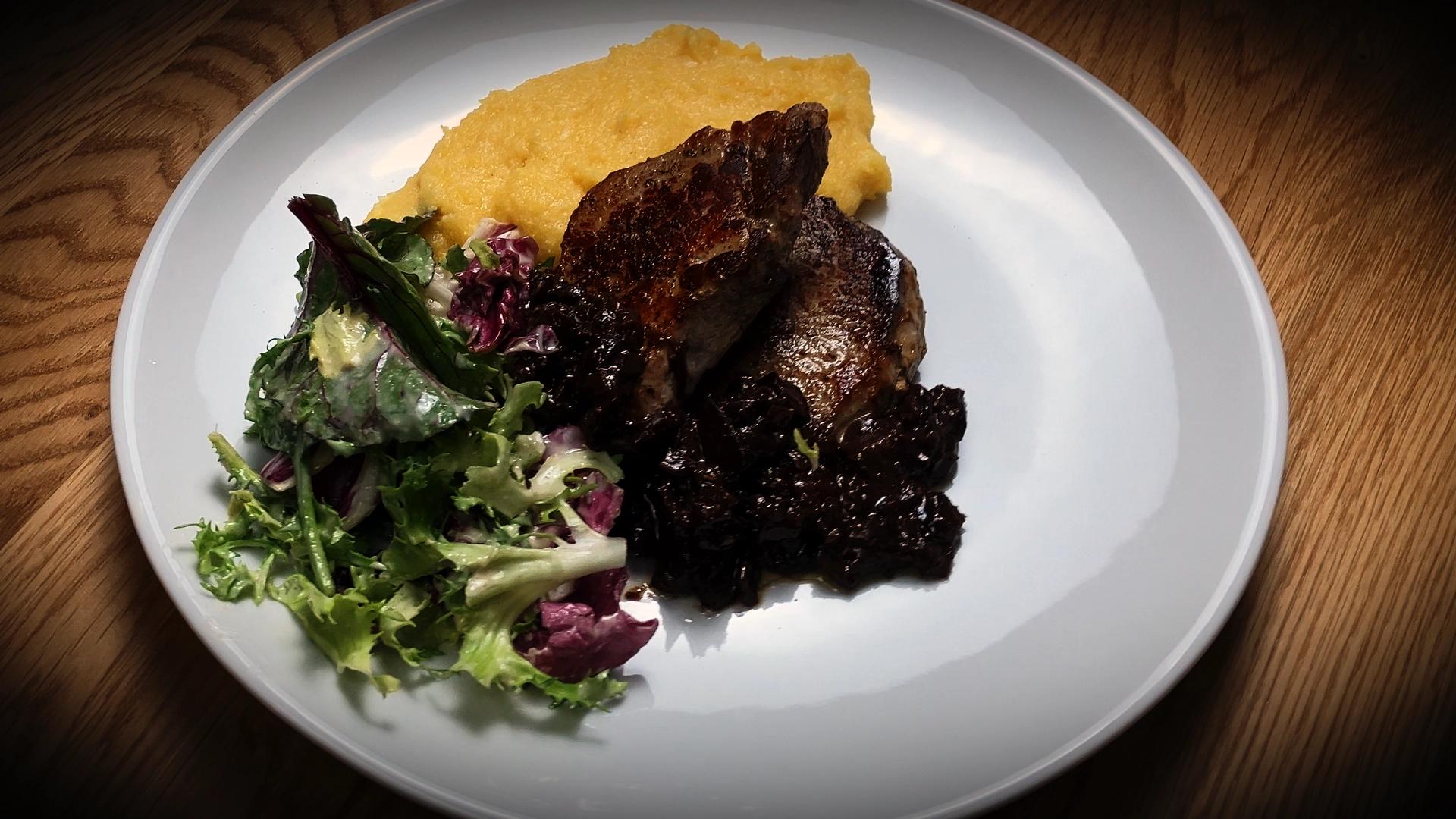 Pork medallions with plum sauce served with creamy polenta and fresh salad - easy home-cooked dinner recipe.